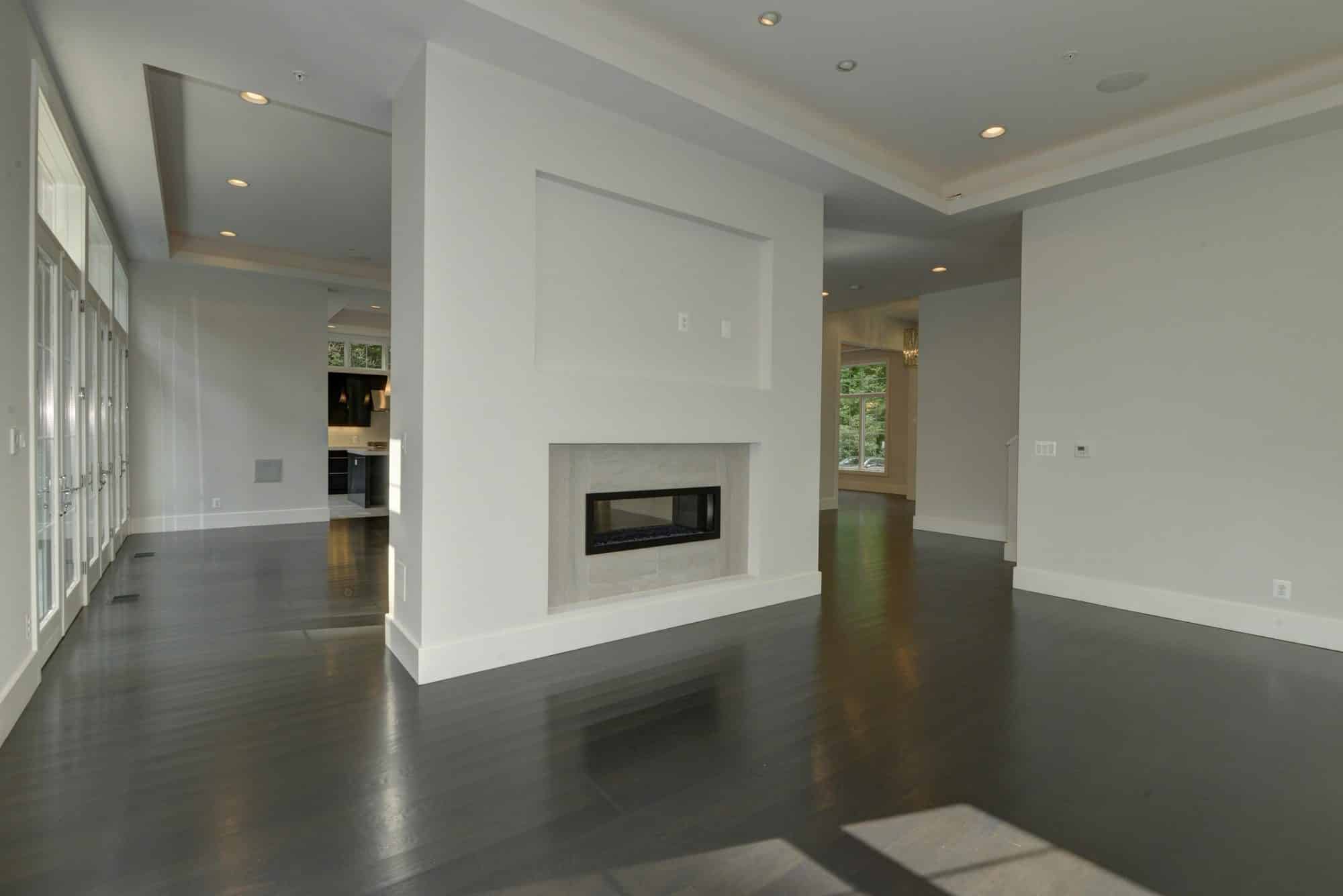 Fireplace anchors two rooms without closing either off.