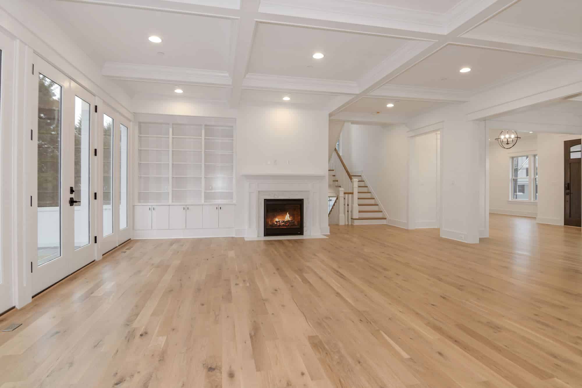 Shelves, fire, staircase - one wall holds the whole room together.