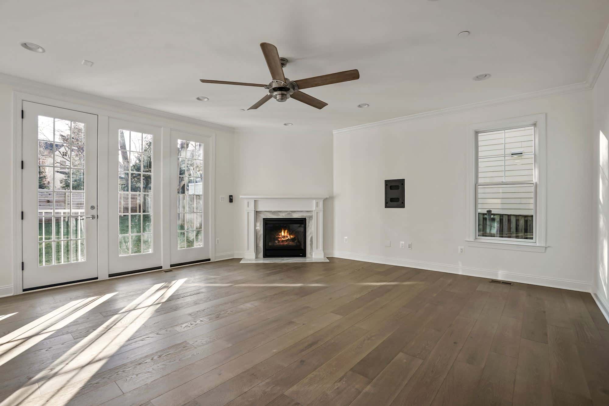 Hearth lit, ceiling fan turning, room already feels lived in.