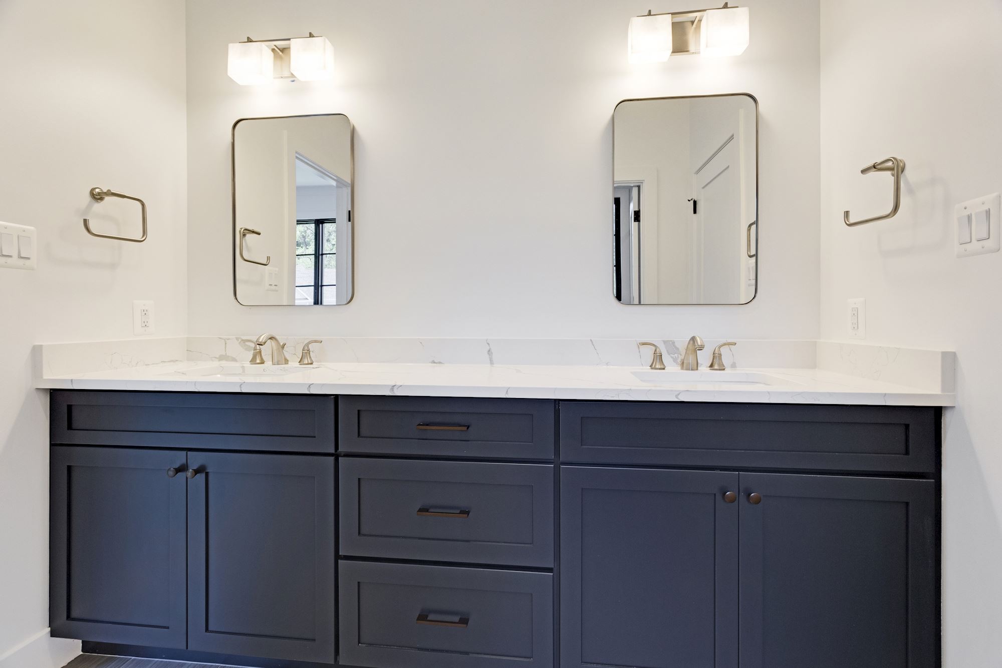 Dual vanities and marble counters set a luxurious tone.
