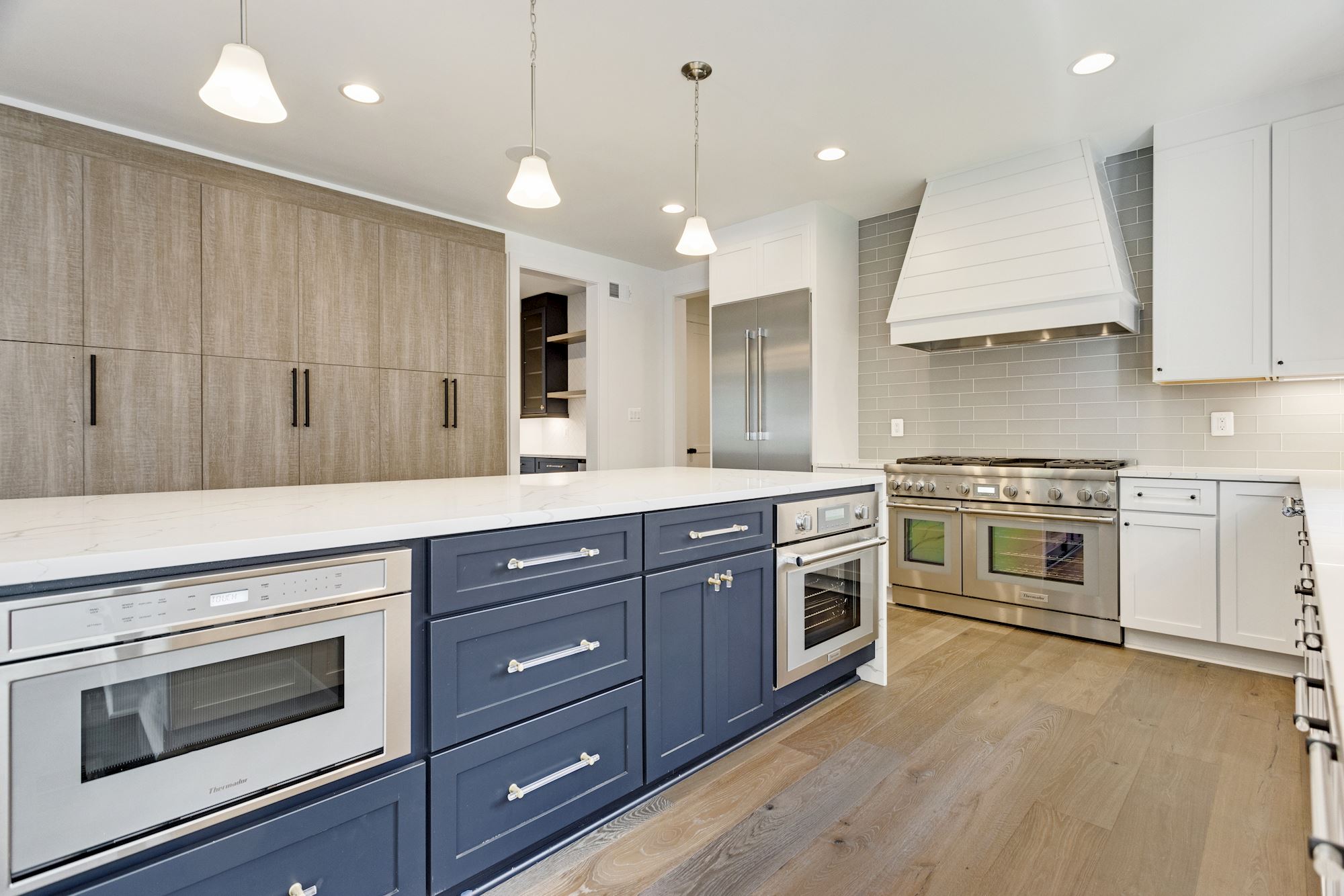 Stone to ceiling, professional appliances, ventilation that means it. This is a working kitchen.