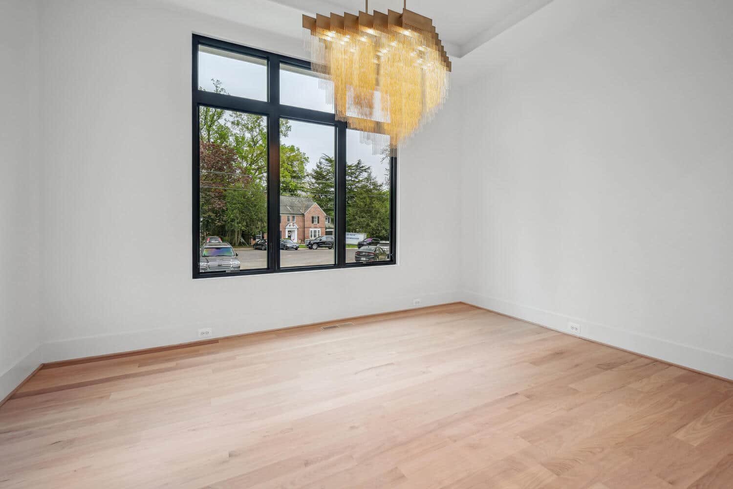 Gold chandelier, bare floor u2014 the table earns its place