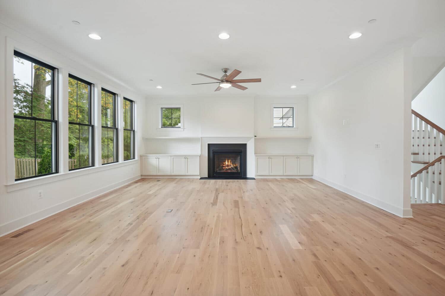 Cabinets low, windows high, the hearth holds the room.