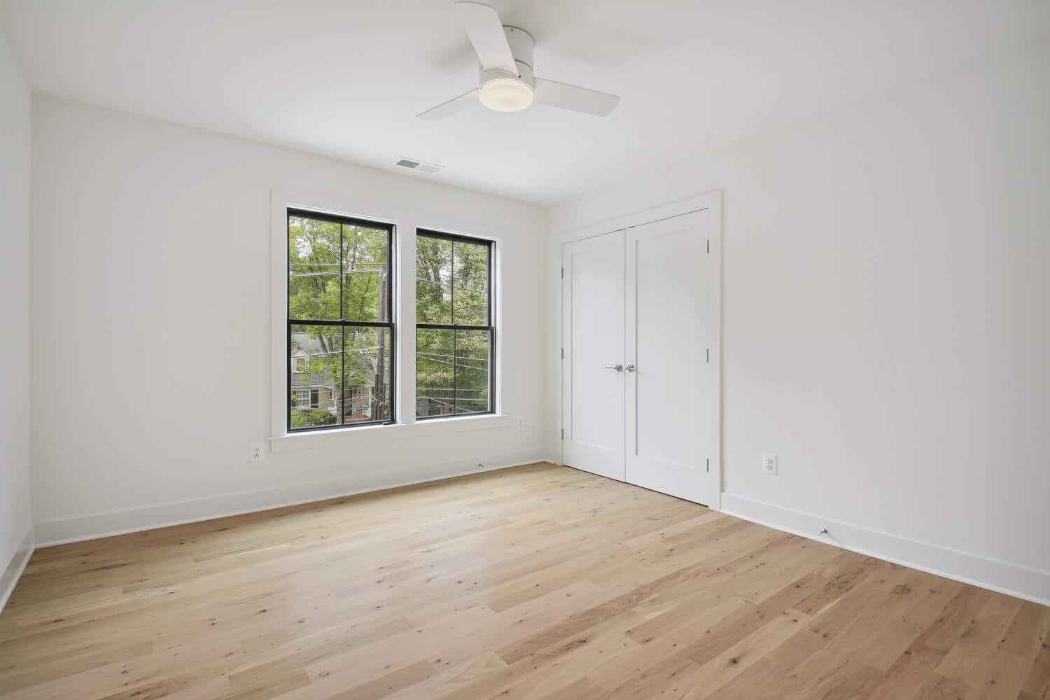 Double doors, tall trees, a room that earns quiet.
