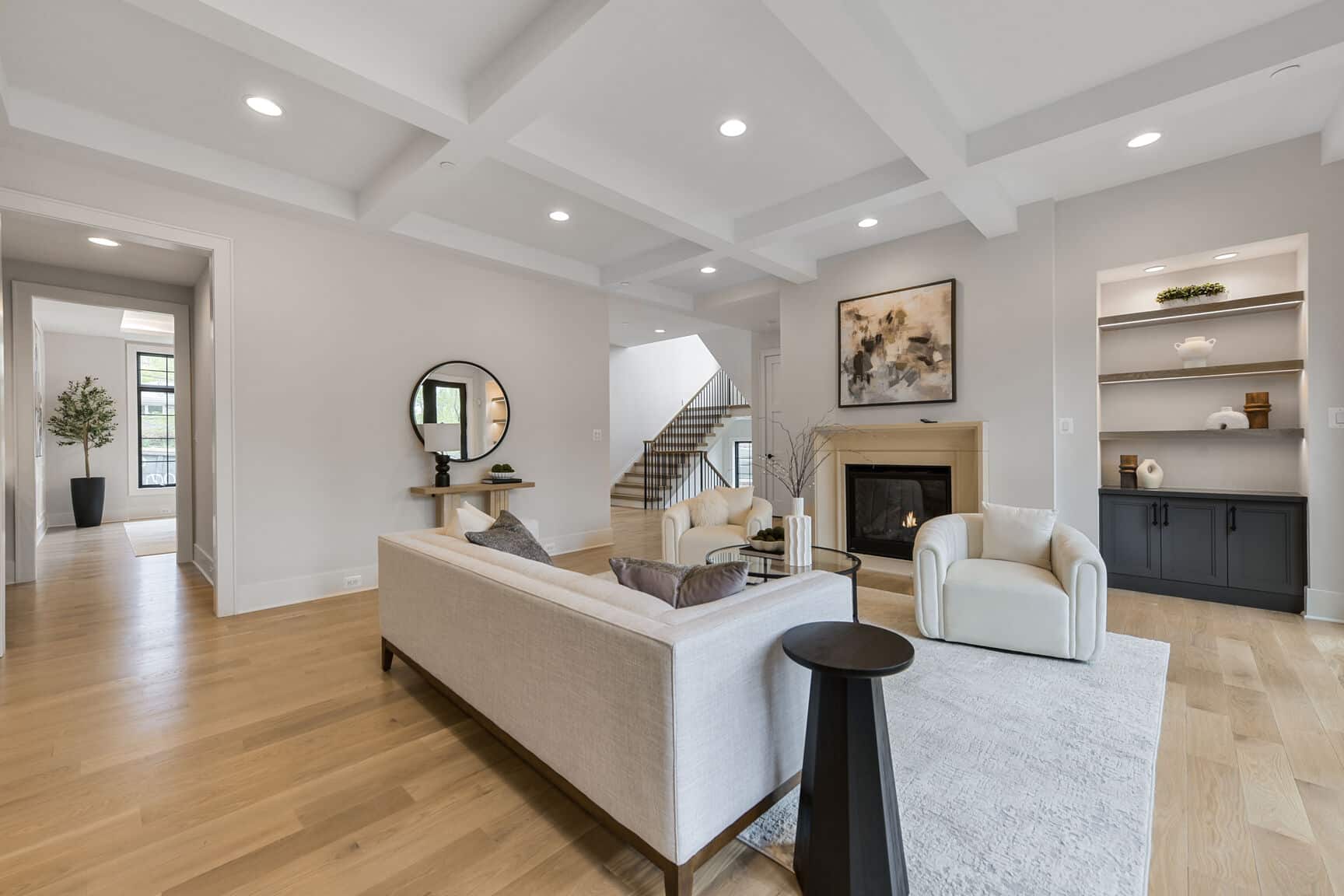Fireplace anchors the room, stairs invite what comes next.