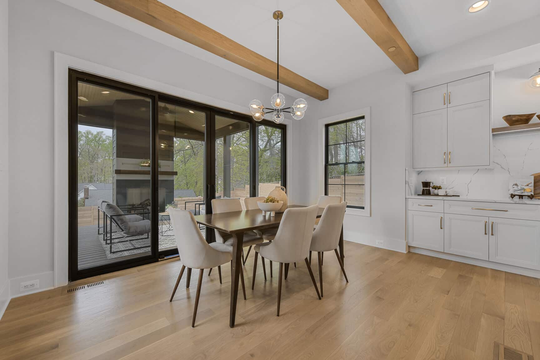 Beamed ceiling, glass doors, the outside earns a seat.