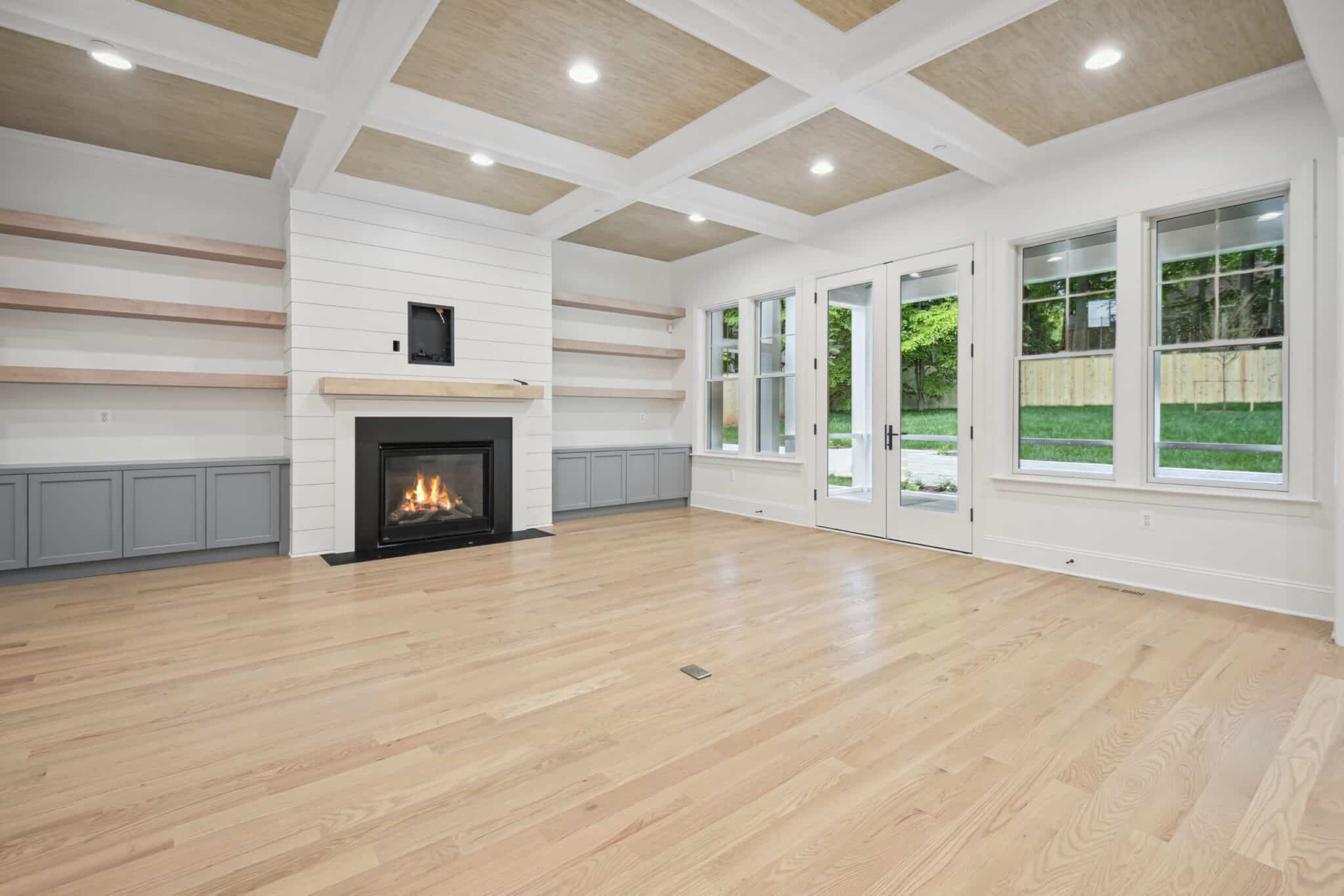 Built-ins flank the fire, glass opens the rear
