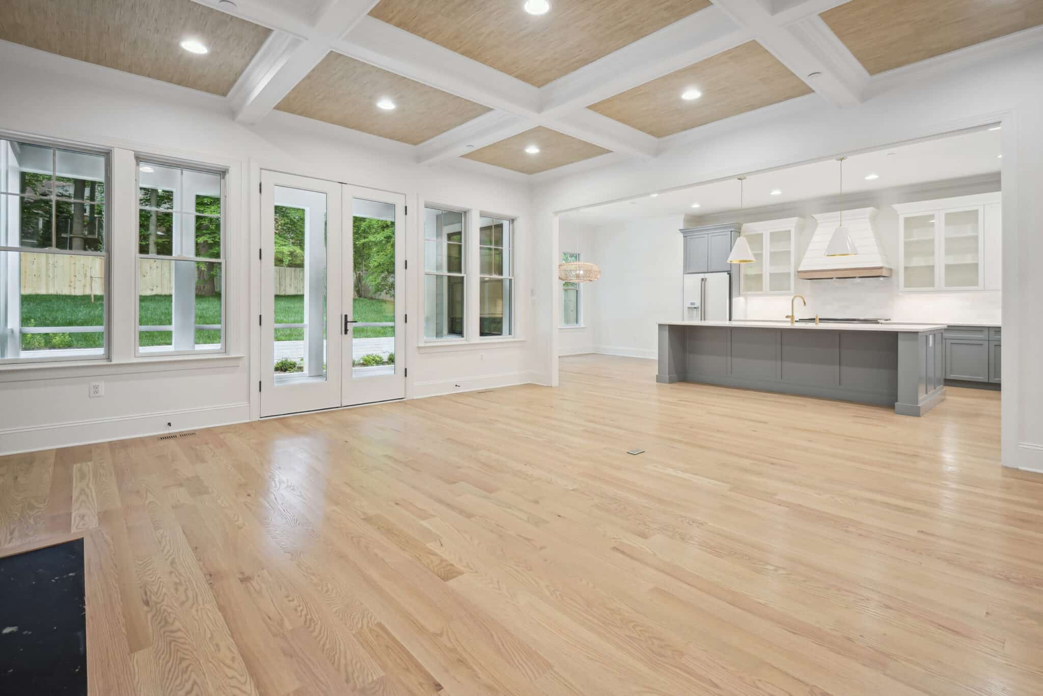 Coffered panels overhead, french doors straight through