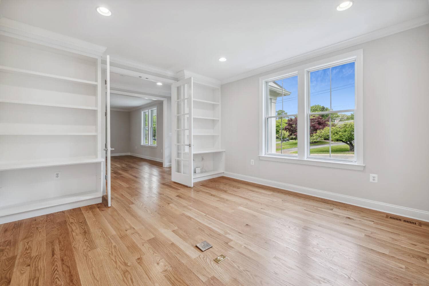 Built-ins frame the room, shelves wait to hold a life.