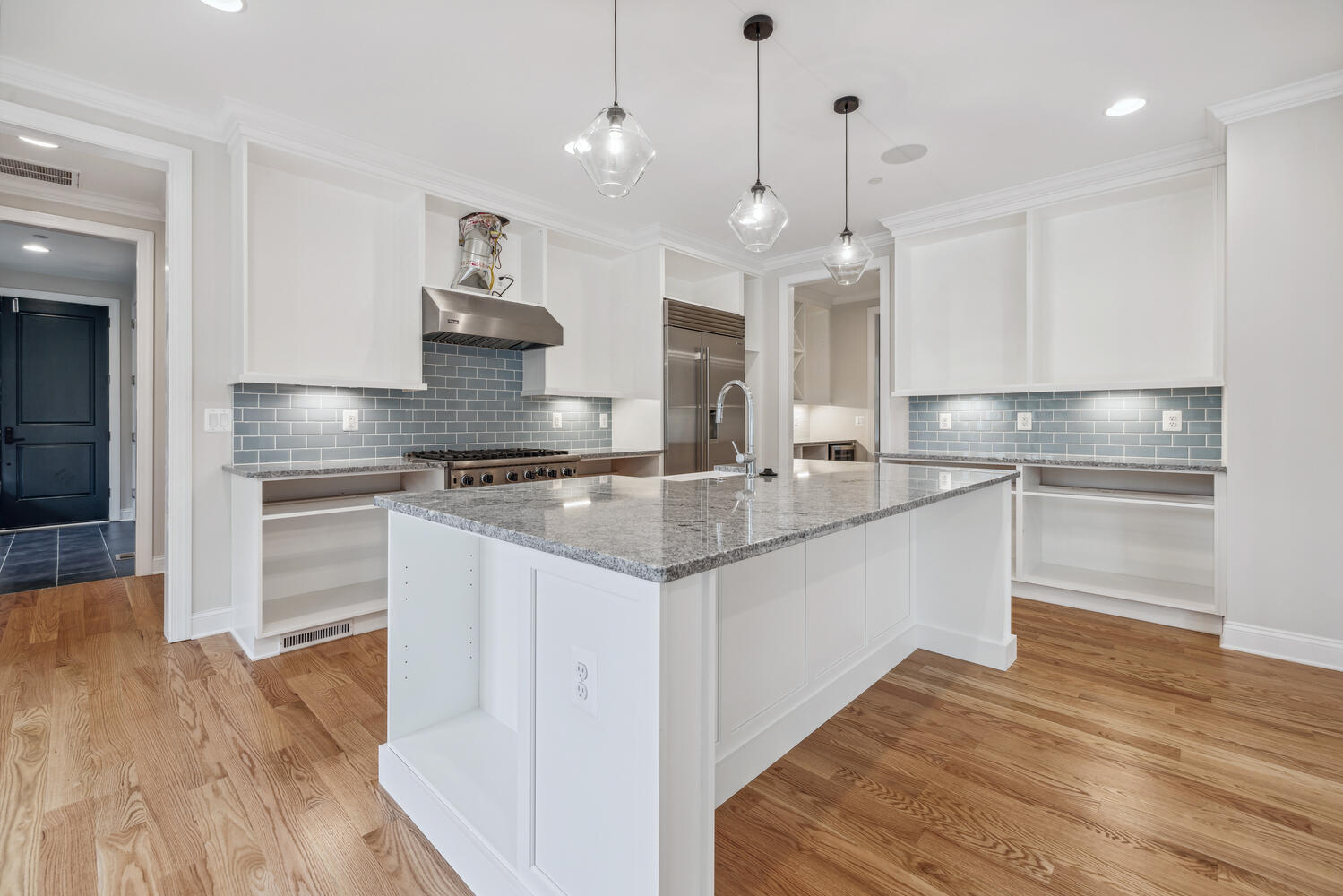 Three pendants, one sink, every angle earns its place.