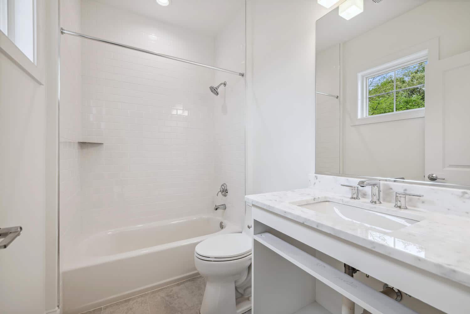 Tub, shower, and marble counter - everything accounted for.