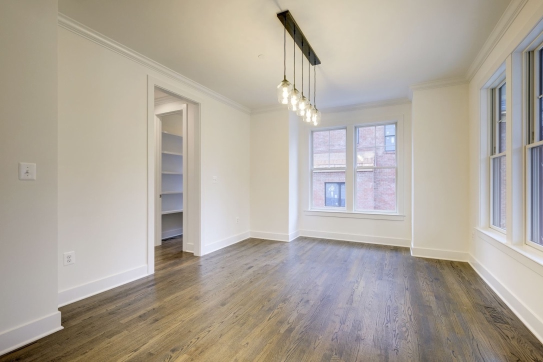 Pendants drop low, floor runs long, room earns its silence.