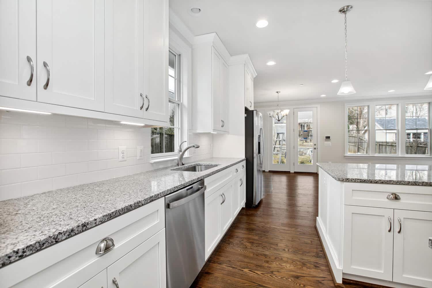 Counters run wall to wall, sink to rear door