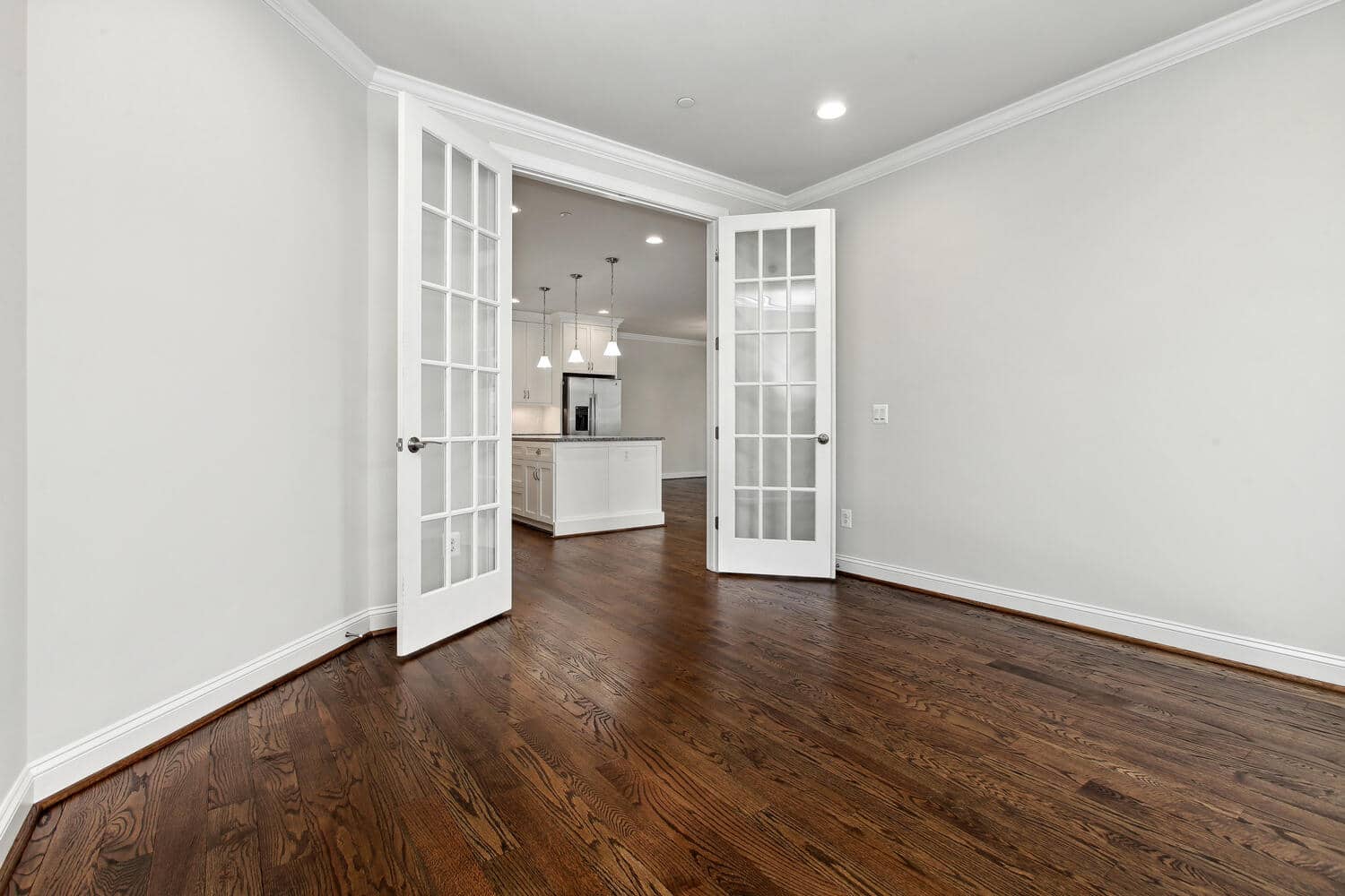 French doors frame the sightline to the kitchen