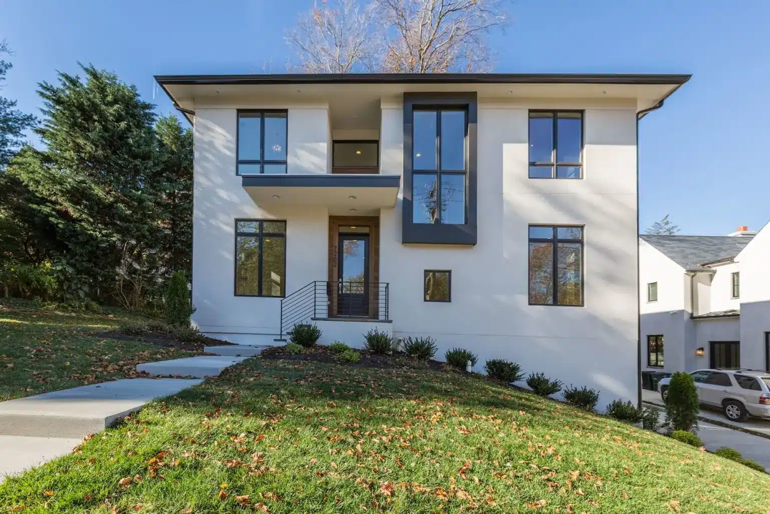White stucco and black steel, quietly confident