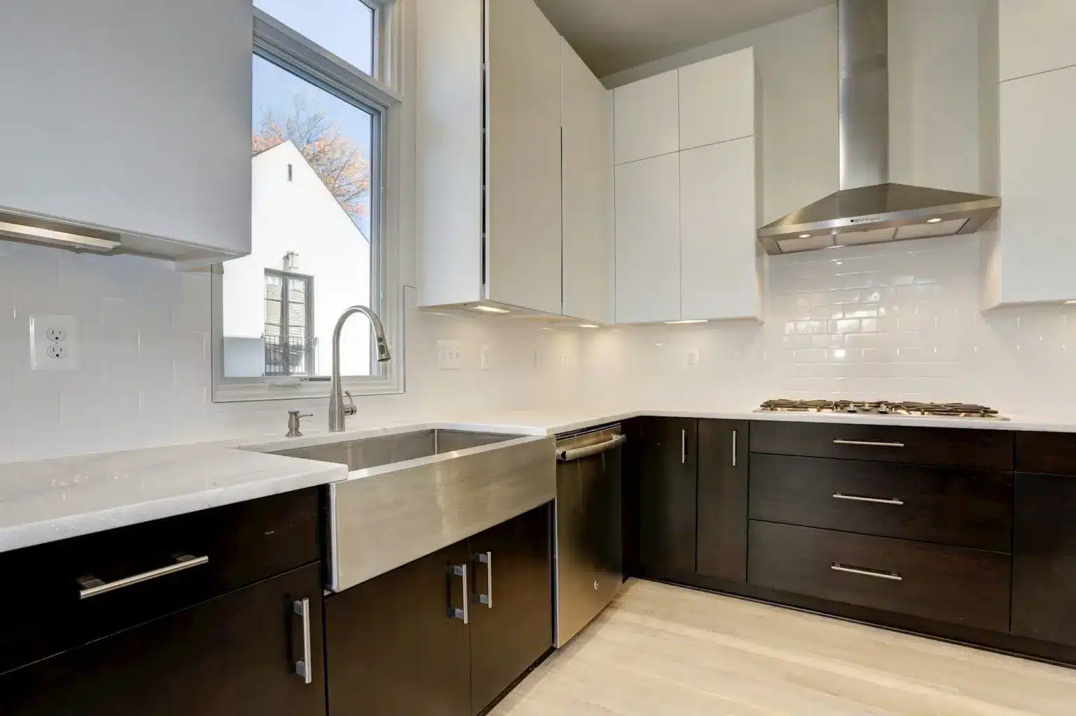 Farmhouse sink under open sky, dark wood holds the weight