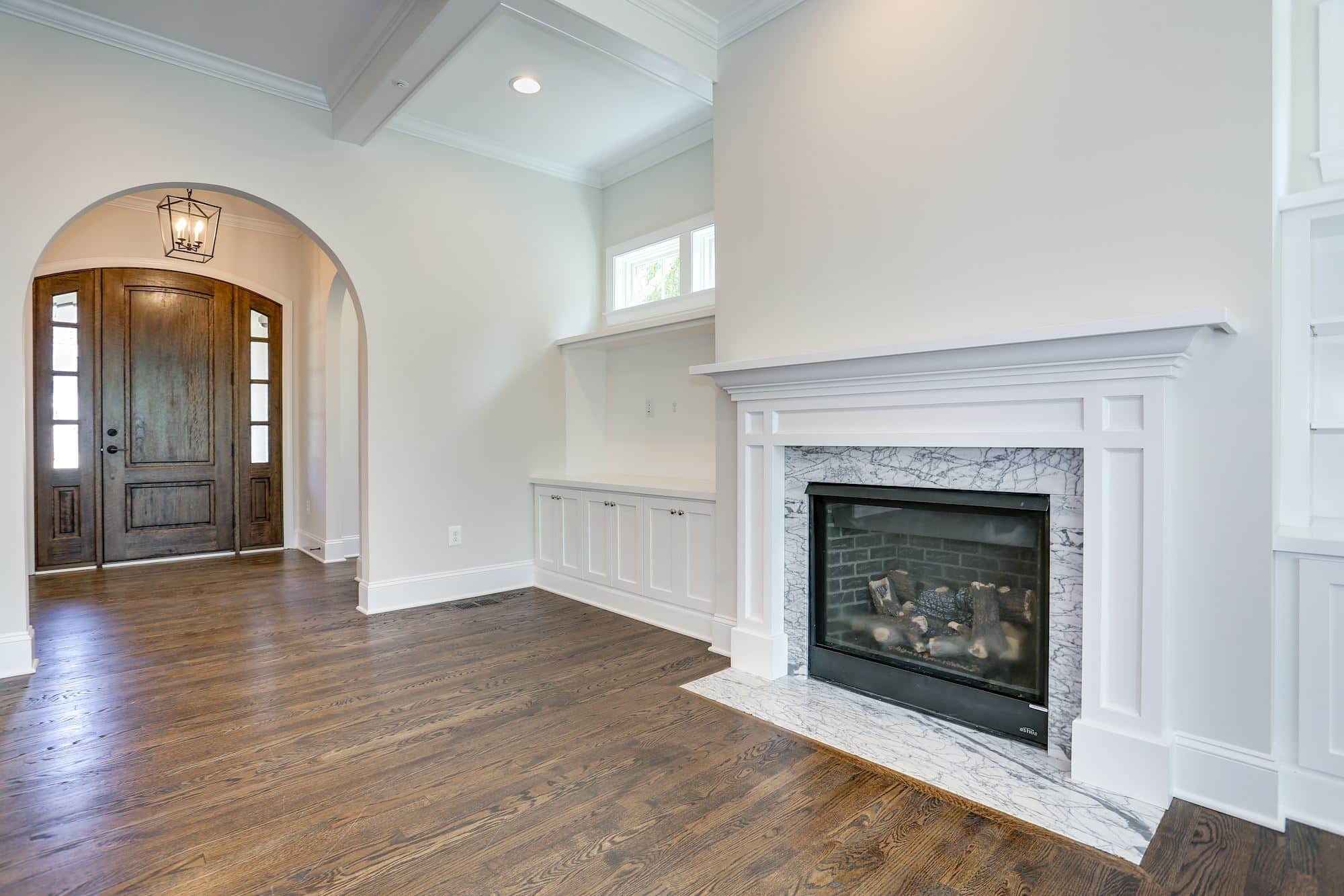 Fireplace anchors the room before furniture ever arrives.