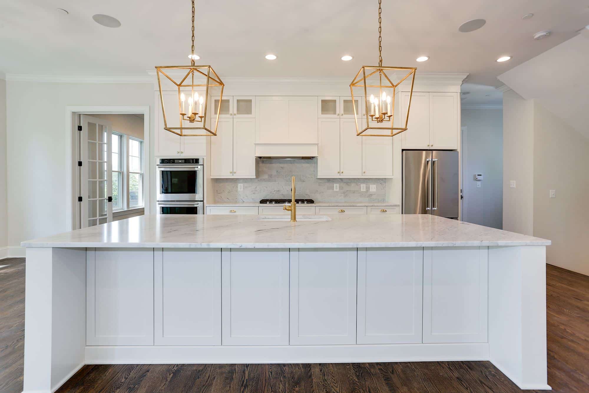Two pendants, one island, the whole room orients itself.