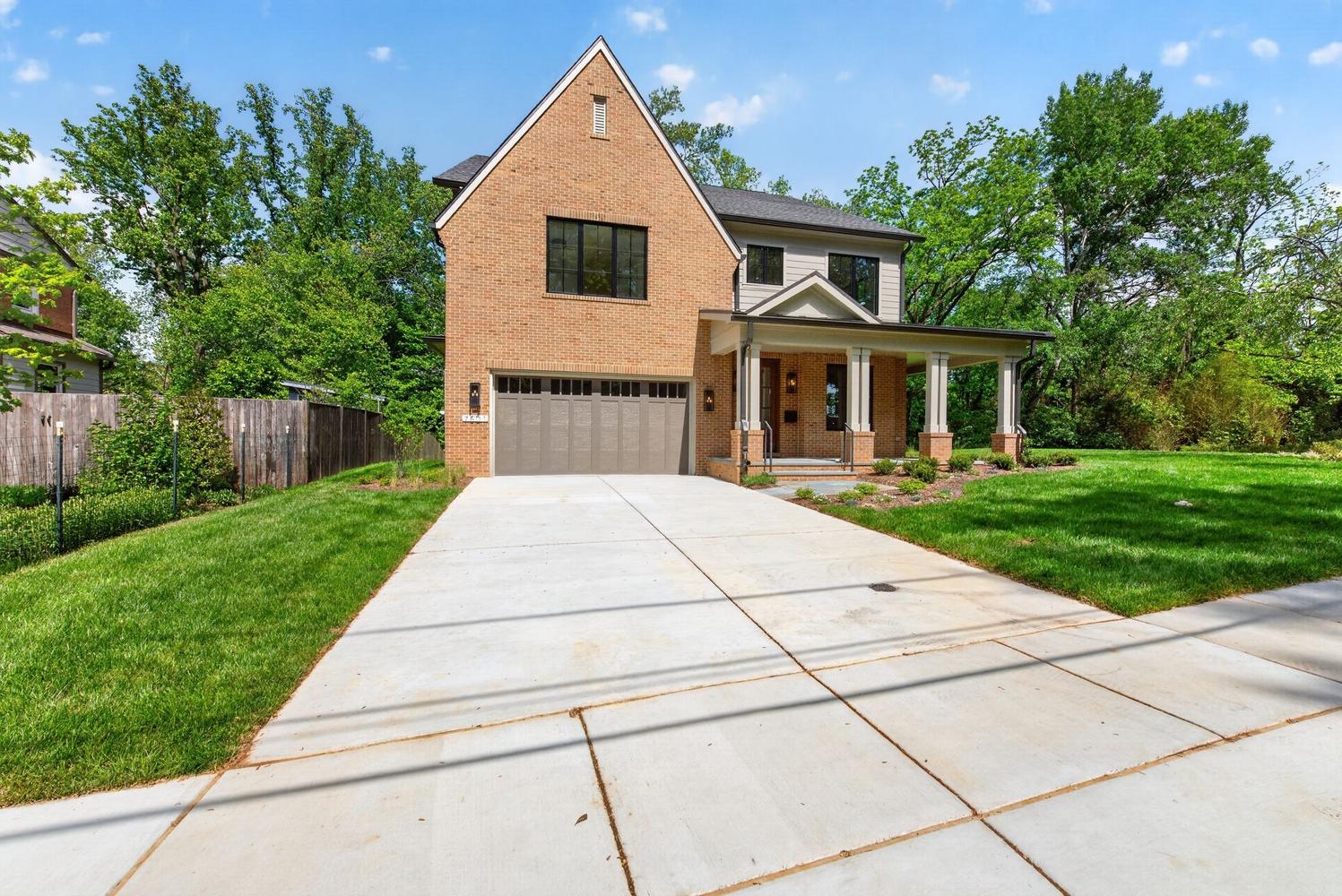 Brick gable rises sharp, porch pulls you in slow.