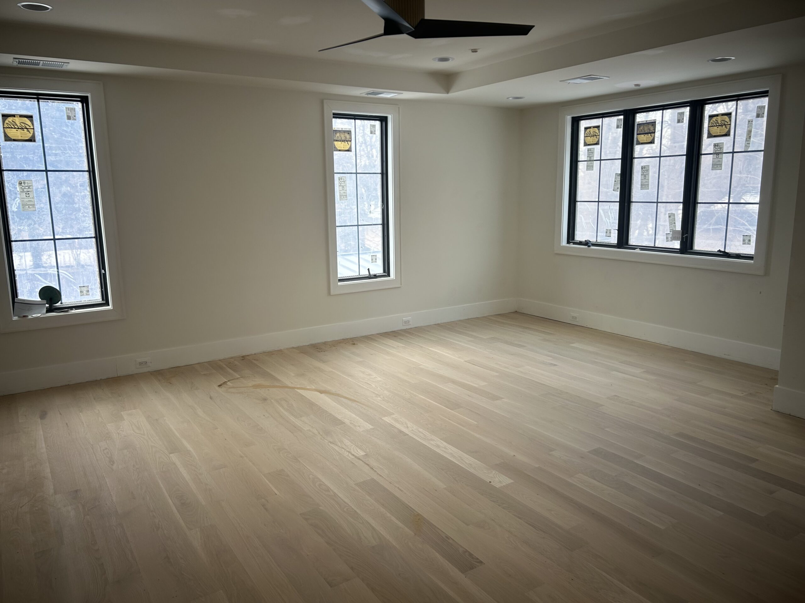 Wide plank floors, natural light from two sides, and enough room that it doesn't need to be staged to feel big.
