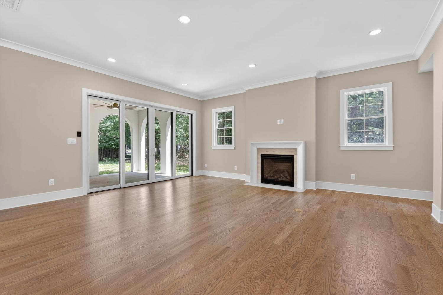 Fireplace anchors the room; the backyard finishes it