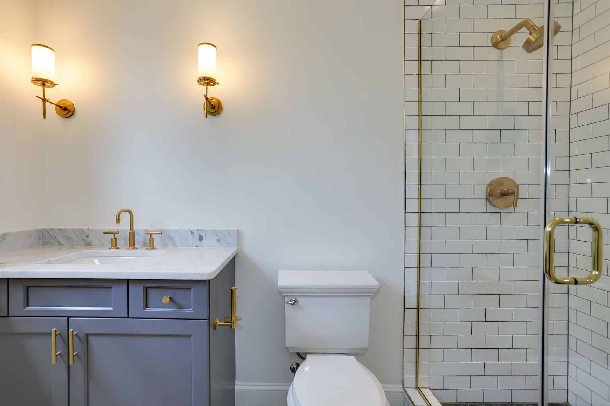 Glass enclosure, sconce symmetry, marble top